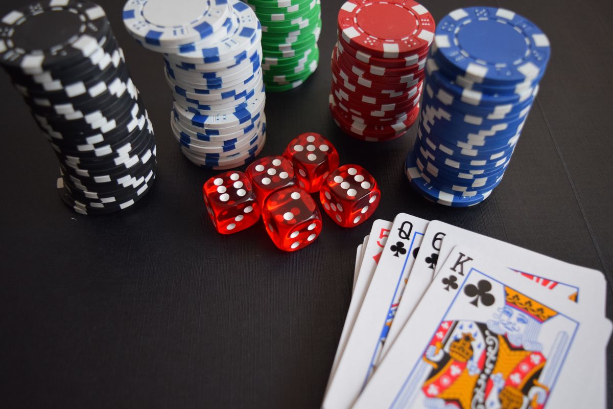 Casino chips, dice and playing cards on a table, representing Supabets' online slots and casino games